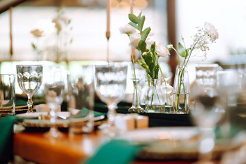 Beautiful flowers on table in wedding day. Beautiful table setting for a party, reception or other festive event emerald colour.