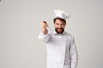 man in chef's uniform tasting food professional cooking work