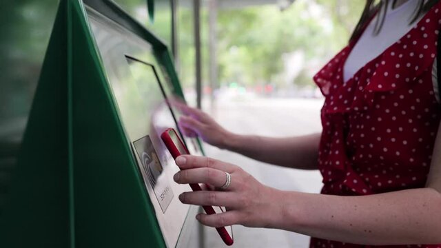 Young adult paying with mobile phone app for the public transport - Tourist making contactless payment on platform station - Travel and commuting concept. High quality 4k footage