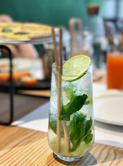 Mojito cocktail with lime and mint in  glass