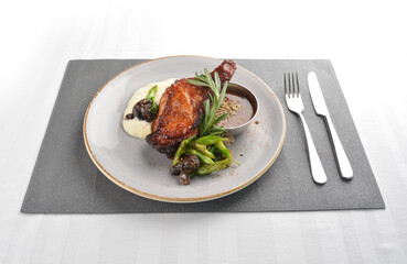 Texas grilled chicken leg confit with vegetables, mash potato and chef brown sauce in white background western main course menu