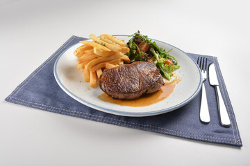 bbq grilled juicy wagyu beef tenderloin sirloin steak in brown black pepper sauce with French fries and vegetables salad dressing western cuisine menu