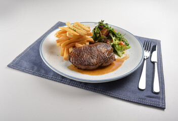 bbq grilled juicy wagyu beef tenderloin sirloin steak in brown black pepper sauce with French fries and vegetables salad dressing western cuisine menu