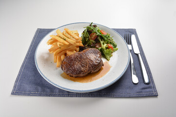 bbq grilled juicy wagyu beef tenderloin sirloin steak in brown black pepper sauce with French fries and vegetables salad dressing western cuisine menu