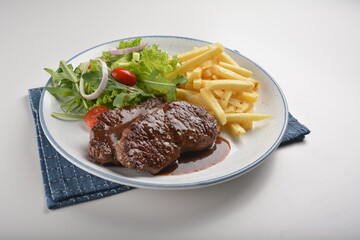 bbq grilled juicy wagyu beef tenderloin sirloin steak in brown black pepper sauce with French fries and vegetables salad dressing western cuisine menu