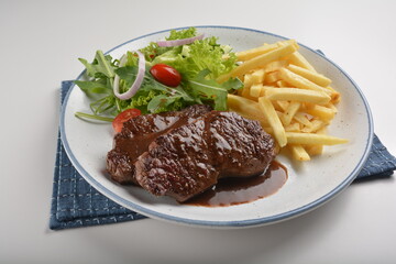 chef bbq grilled juicy wagyu beef tenderloin sirloin steak in brown black pepper sauce with French fries and vegetables salad dressing hotel fine dining western restaurant cafe halal cuisine menu