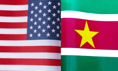 fragments of the national flags of the United States and Suriname in close-up