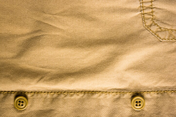 clothing items stonewashed cotton fabric texture with seams, clasps, buttons and rivets, macro