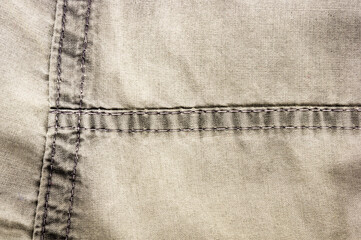 clothing items stonewashed cotton fabric texture with seams, clasps, buttons and rivets, macro