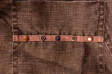 clothing items stonewashed cotton fabric texture with seams, clasps, buttons and rivets, macro