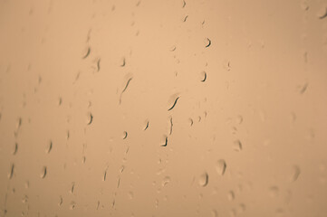 Natural summer background - raindrops on the window glass, close up.