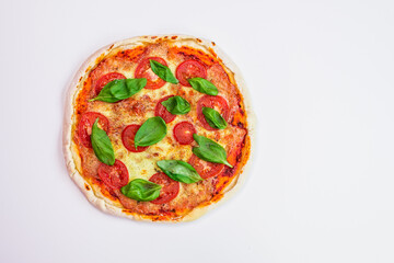 freshly baked Italian pizza with cheese and tomato sauce, garnished with basil leaves. Ingredients. view from above 