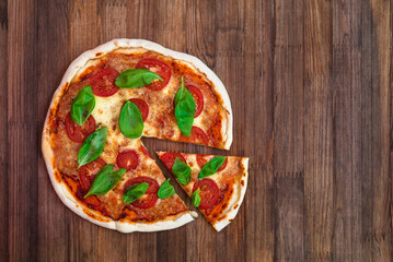 freshly baked Italian pizza with cheese and tomato sauce, garnished with basil leaves. Ingredients. view from above 