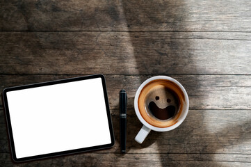 Top view of blank screen tablet, pen and cup of coffee on wooden table backgrond with copy space.