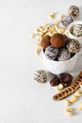 Fototapeta na wymiar Carob energy balls with nuts, dates and coconut, vegan and vegetarian sweet food