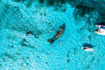 People snorkelling around the ship wreck near Cancun in the Caribbean sea. Beautiful turquoise...