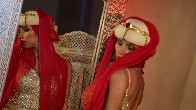 alluring oriental princess is dancing against mirror, turkish fairy tale