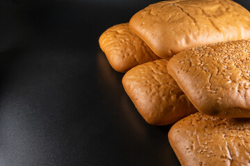 panini bun, sandwich. Without ingredients, on a black background. Bakery production concept.