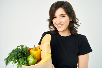 brunette with a package of groceries vegetables healthy food delivery from supermarket