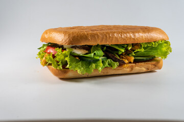 ciabatta sandwich with chicken and vegetables isolated on white background. Concept for the production of fast food bread. Bakery products