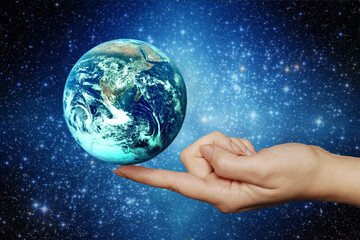 woman hand holding the planet Earth on her finger