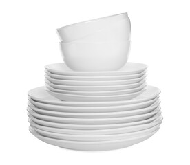 Stacked plates and cups on white background