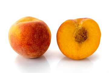 Italian Percoca peach variety with yellow flesh, one whole and another in cross section, isolated on white, copy space