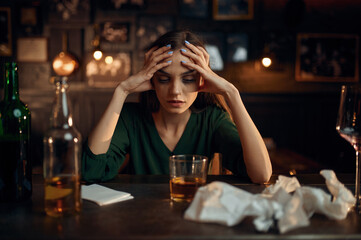 Drunk depressed woman at the counter in bar