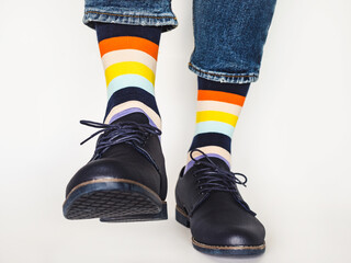 Men's legs, trendy shoes and bright socks. Close-up. Style, beauty and elegance concept