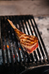 Juicy steak is grilled in a restaurant. Roasting meat in the fire on the grill.