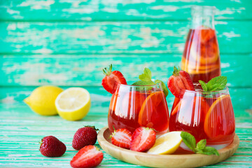 Homemade strawberry lemonade on a rustic background, a refreshing summer drink, selective focus