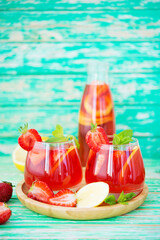 Homemade strawberry lemonade on a rustic background, a refreshing summer drink, selective focus