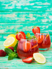 Homemade strawberry lemonade on a rustic background, a refreshing summer drink