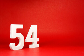 Fifty four ( 54 ) white number wooden Isolated Red Background with Copy Space - New promotion 54%...