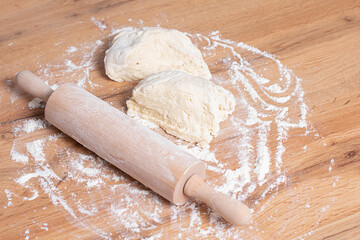 Rolling pin and dough. Woman preparing dough