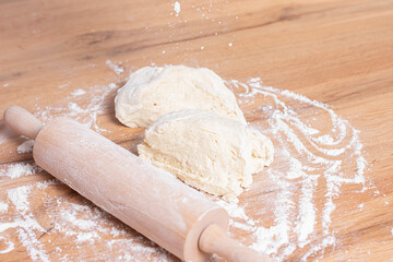 Rolling pin and dough. Woman preparing dough