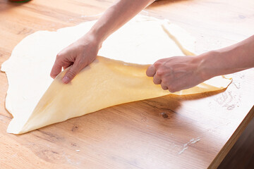 Rolling pin and dough. Woman preparing dough
