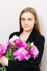 Beautiful lady holding a bouquet of fresh flowers