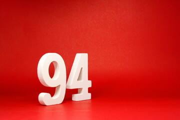 Ninety Four ( 94 ) white number wooden on Red Background with Copy Space - New promotion 94%...