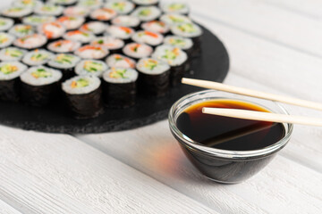Set of sushi rolls on black plate