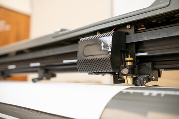 Fototapeta na wymiar Cutting plotter close-up. The process of cutting a vinyl film