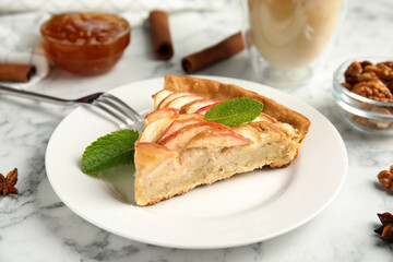 Slice of delicious apple pie on white marble table