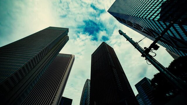 A timelapse of clowd at the building in the business town wide shot tilt