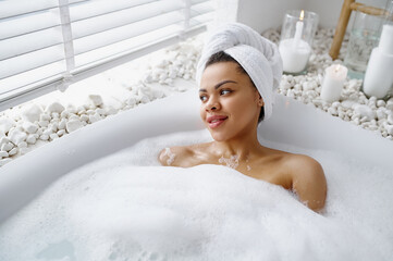 Seductive woman relax in a bubble bath