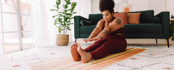 Healthy female doing fitness training at home