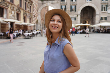 Fashionable young woman visiting the city of Verona in Italy in her cultural tour in Europe.