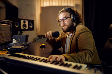 Sound engineer holds microphone, recording studio
