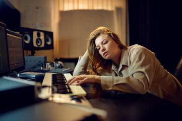 Fototapeta na wymiar Tired female sound engineer, hard creative process