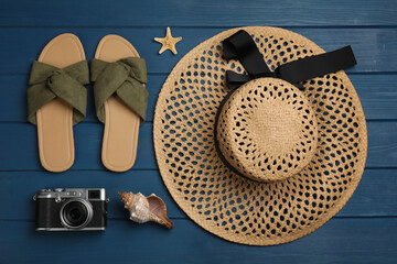 Flat lay composition with beach objects on blue wooden background