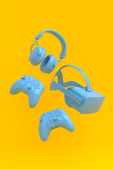 Flying gamer gears like VR glasses, headphones and joystick on yellow background